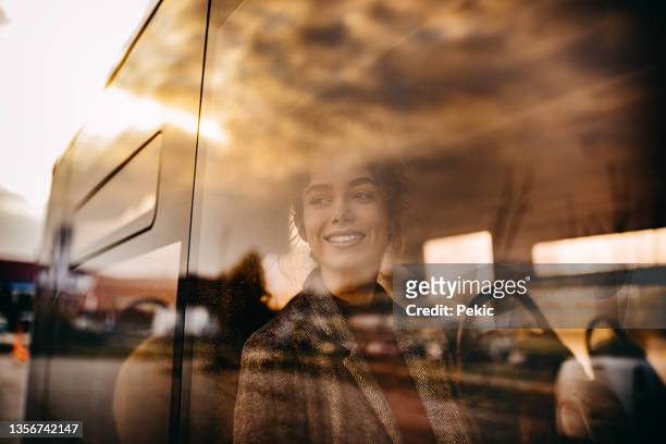 young beautiful woman riding in public bus - bus travel stock pictures, royalty-free photos & images