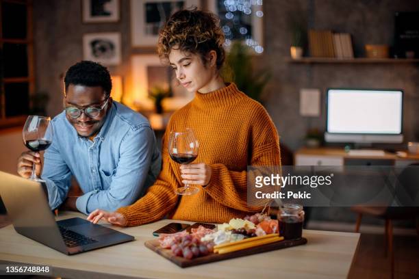 lets find something to watch - young couple date night wine stock pictures, royalty-free photos & images