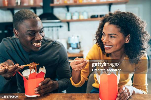 take away food at home - 30s woman eating stock pictures, royalty-free photos & images