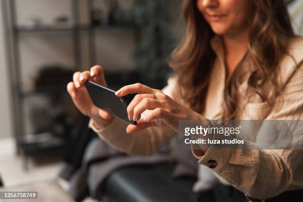woman using ar augmented reality on her smartphone - augmented reality stock pictures, royalty-free photos & images