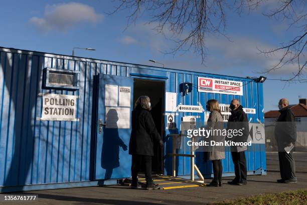 Members of the public arrive to cast their vote at a polling station during the Old Bexley and Sidcup by-election on December 02, 2021 in Bexley,...
