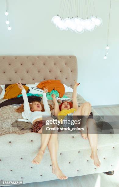 blond woman and redhead laying on back in bed - blonde long legs stock pictures, royalty-free photos & images