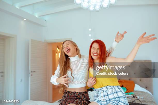 women playing the air guitar - air guitar stock pictures, royalty-free photos & images