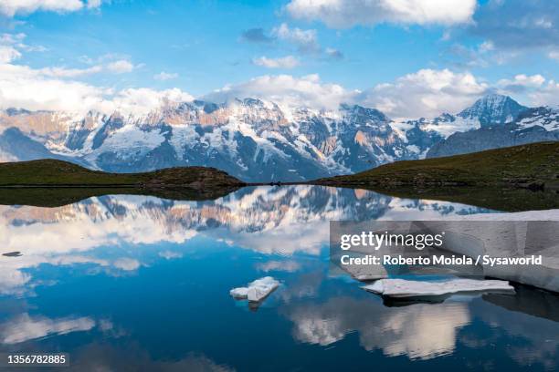 mountain peaks reflected in grauseeli lake, switzerland - lauterbrunnen stock pictures, royalty-free photos & images