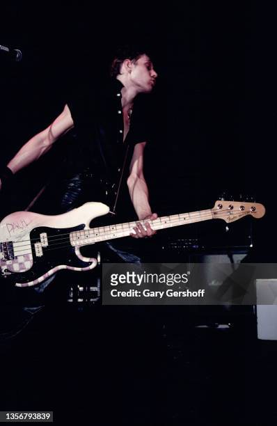 British Punk musician Paul Simonon, of the group the Clash, plays bass guitar as he performs onstage at the Capitol Theatre, Passaic, New Jersey,...