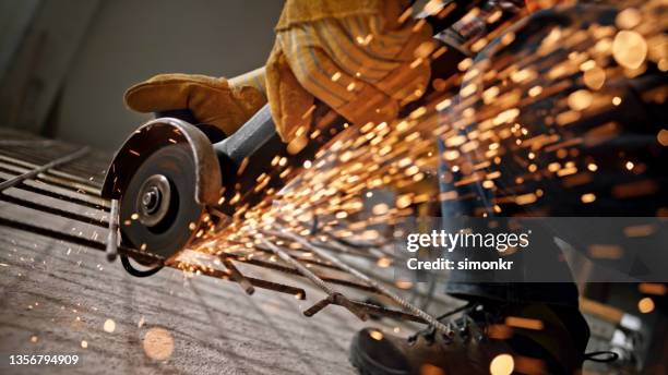 construction worker cutting metal grate at site - rebar stock pictures, royalty-free photos & images