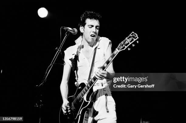 British Punk musician Mick Jones, of the group the Clash, plays guitar as he performs onstage at the Capitol Theatre, Passaic, New Jersey, March 8,...