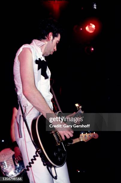 British Punk musician Mick Jones, of the group the Clash, plays guitar as he performs onstage at the Capitol Theatre, Passaic, New Jersey, March 8,...