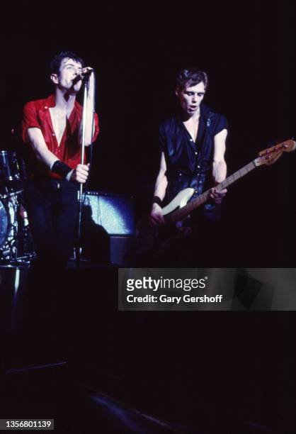 British Punk musicians Joe Strummer and Paul Simonon, on bass guitar, both of the group the Clash, perform onstage at the Capitol Theatre, Passaic,...