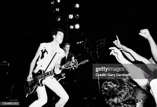 British Punk musician Mick Jones, of the group the Clash, plays guitar as he performs onstage at the Capitol Theatre, Passaic, New Jersey, March 8,...