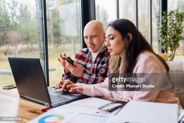 two freelancers working in the coffee shop - cellphone cancer illness stock pictures, royalty-free photos & images