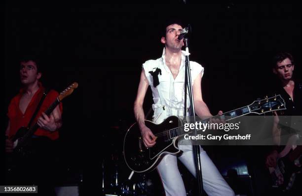 British Punk musician Mick Jones , of the group the Clash, plays guitar as he performs onstage at the Capitol Theatre, Passaic, New Jersey, March 8,...