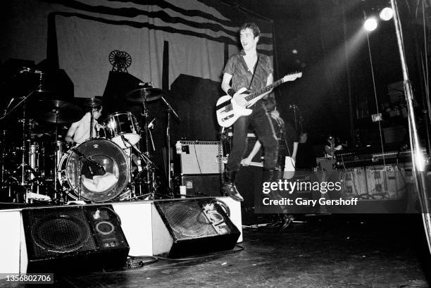 British Punk musician Joe Strummer , of the group the Clash, plays guitar and jumps in the air as he performs onstage at the Capitol Theatre,...