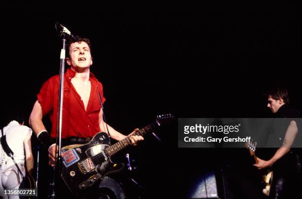 British Punk musician Joe Strummer , of the group the Clash, plays guitar as he performs onstage at the Capitol Theatre, Passaic, New Jersey, March...