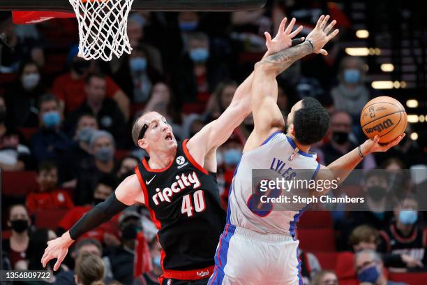 Cody Zeller of the Portland Trail Blazers defends Trey Lyles of the Detroit Pistons during the second quarter at Moda Center on November 30, 2021 in...