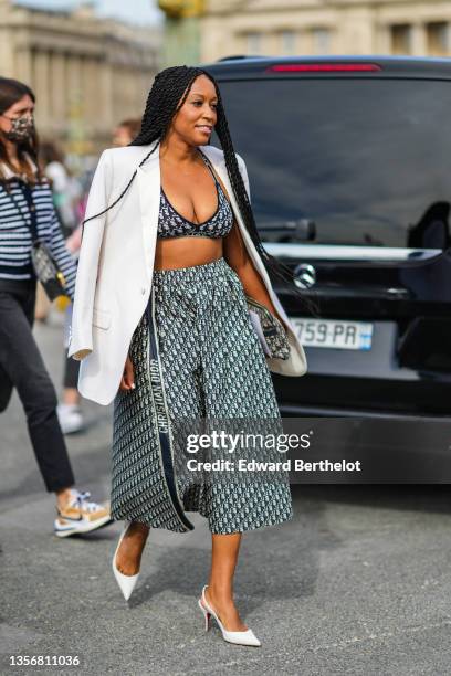 Guest wears a white oversized blazer jacket, a blue and beige Dior Oblique Jacquard V-neck bra underwear from Dior, a high waist blue and beige Dior...