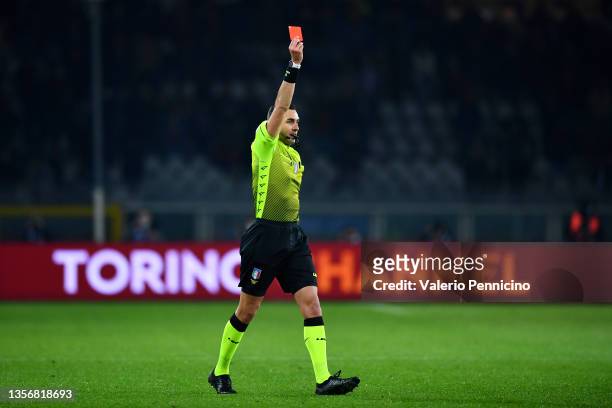 Referee Andrea Colombo shows a red card to Wilfried Singo of Torino FC after referring to VAR during the Serie A match between Torino FC and Empoli...