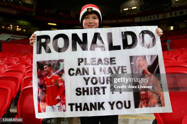 Fan of Manchester United holds up a sign asking for the shirt of Cristiano Ronaldo of Manchester United prior to the Premier League match between...