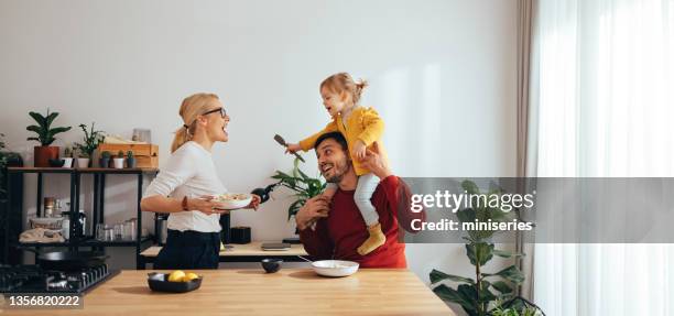 family playing while having a healthy breakfast in the kitchen - family panoramic stock pictures, royalty-free photos & images