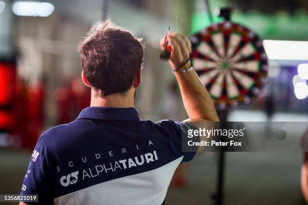 Pierre Gasly of Scuderia AlphaTauri and France playing darts during previews ahead of the F1 Grand Prix of Saudi Arabia at Jeddah Corniche Circuit on...