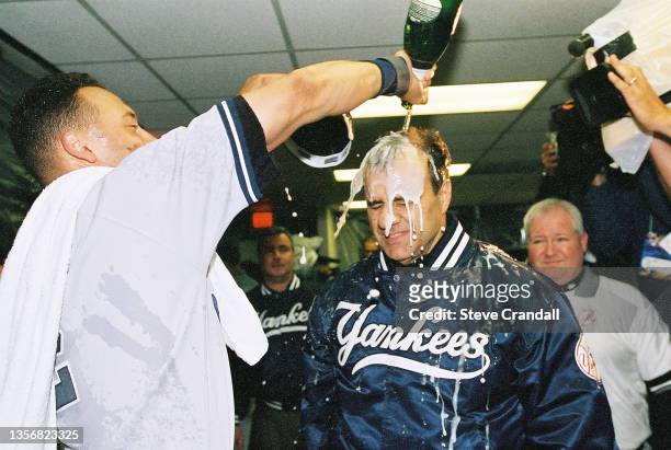 New York Yankees ss, Derek Jeter, gives Manager Joe Torre a champagne shower after winning the 2000 ALDS on October 09, 2000 in New York.