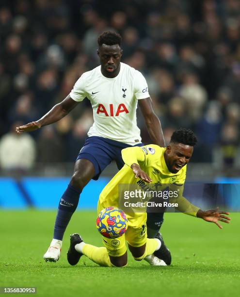 Davinson Sanchez of Tottenham Hotspur tackles Frank Onyeka of Brentford during the Premier League match between Tottenham Hotspur and Brentford at...