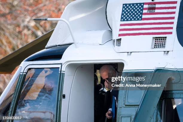 President Joe Biden adjusts his face mask as he walks off Marine One on the South Lawn after returning to the White House on December 02, 2021 in...