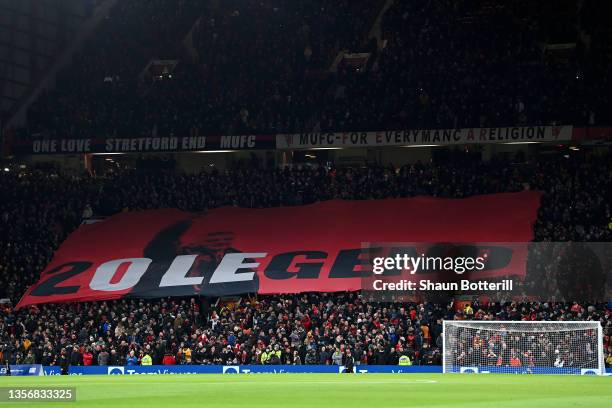 Fans of Manchester United wave a flag in support of Former Player and Manager, Ole Gunnar Solskjaer prior to the Premier League match between...