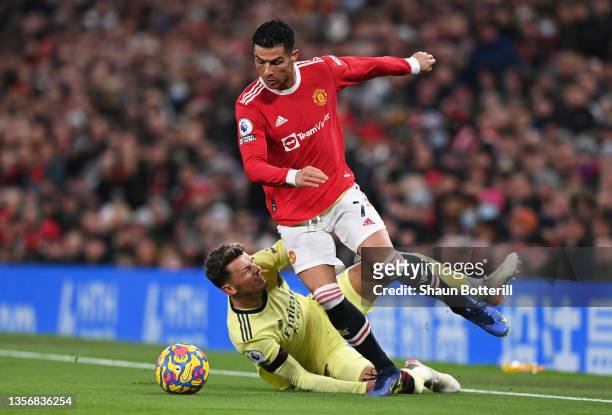 Cristiano Ronaldo of Manchester United evades the tackle of Ben White of Arsenal during the Premier League match between Manchester United and...