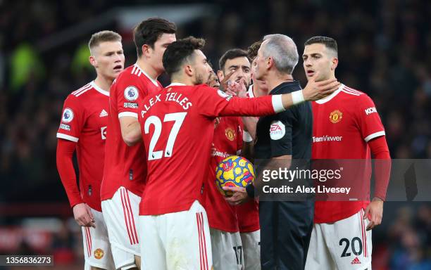 Players of Manchester United interact with Match Referee, Martin Atkinson after a goal scored by Emile Smith Rowe of Arsenal is given following a VAR...