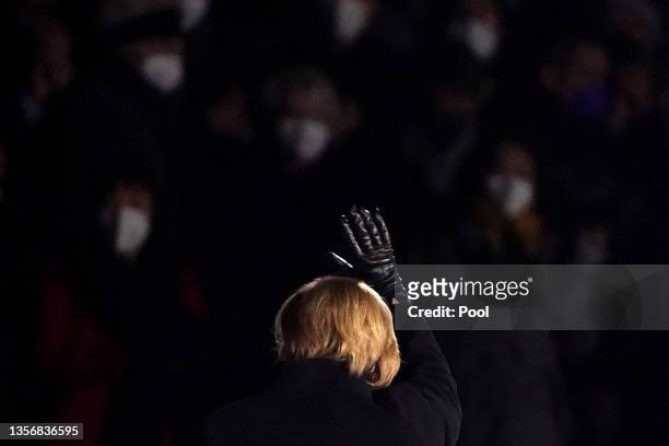 Outgoing German Chancellor Angela Merkel waves as she leaves the military tattoo ceremony hosted for her by the Bundeswehr on December 02, 2021 in...