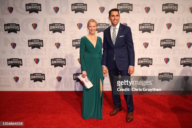 Cup Series driver Aric Almirola and wife Janice Almirola pose on the red carpet prior to the NASCAR Champion's Banquet at the Music City Center on...