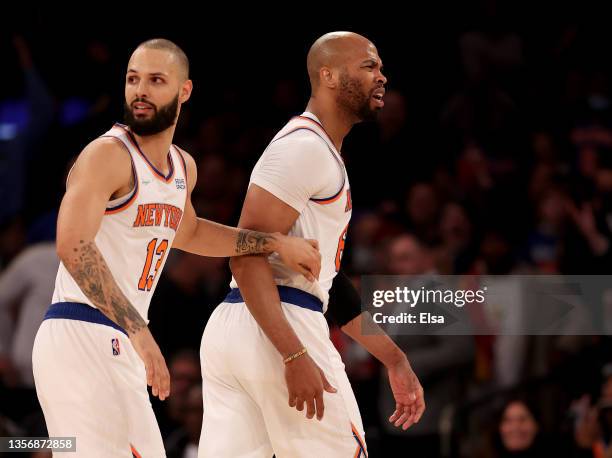 Taj Gibson of the New York Knicks is held back by teammate Evan Fournier after Gibson is called for double technical fouls and is ejected from the...