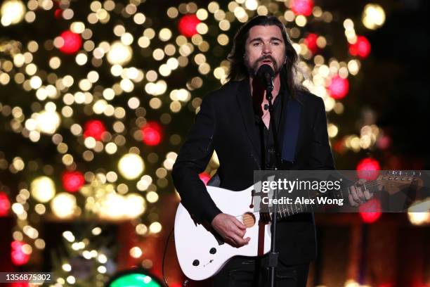 Singer Juanes performs at the lighting of the national Christmas tree on the Ellipse December 2, 2021 in Washington, DC. A new white fir was planted...