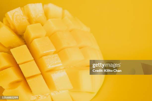 slice of mango fruit again yellow background - mango 個照片及圖片檔