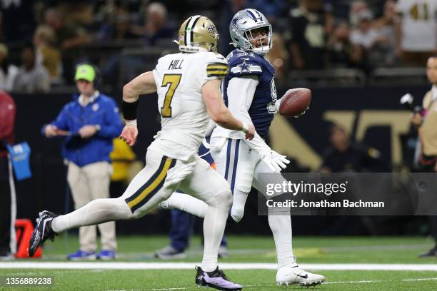 Carlos Watkins of the Dallas Cowboys runs into the endzone for a touchdown as Taysom Hill of the New Orleans Saints defends in the fourth quarter of...