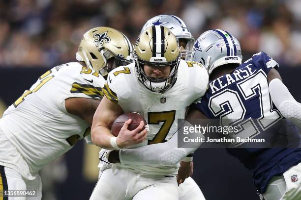 Taysom Hill of the New Orleans Saints is tackled by Jayron Kearse of the Dallas Cowboys in the third quarter of the game at Caesars Superdome on...