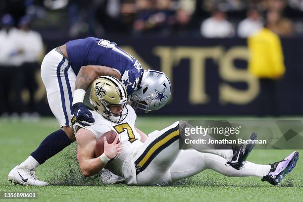 Taysom Hill of the New Orleans Saints is sacked by Micah Parsons of the Dallas Cowboys in the fourth quarter of the game at Caesars Superdome on...
