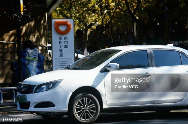 Car stops in front of a designated pick-up point of Chinese ride-hailing platform Didi Chuxing on December 3, 2021 in Hangzhou, Zhejiang Province of...
