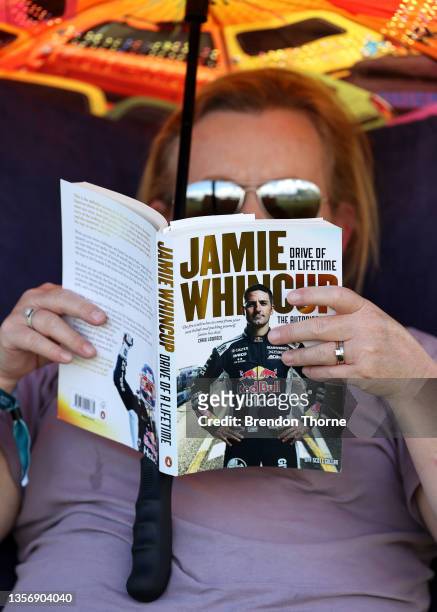 Race fan reads the biography of Jamie Whincup during qualifying for the Bathurst 1000 which is part of the 2021 Supercars Championship, at Mount...