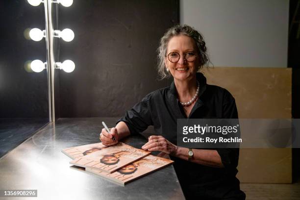 Photographer Anne Geddes signs magazines as she attends Bella Magazine's Arts + Culture Cover Party at Blonde Studios on December 02, 2021 in New...