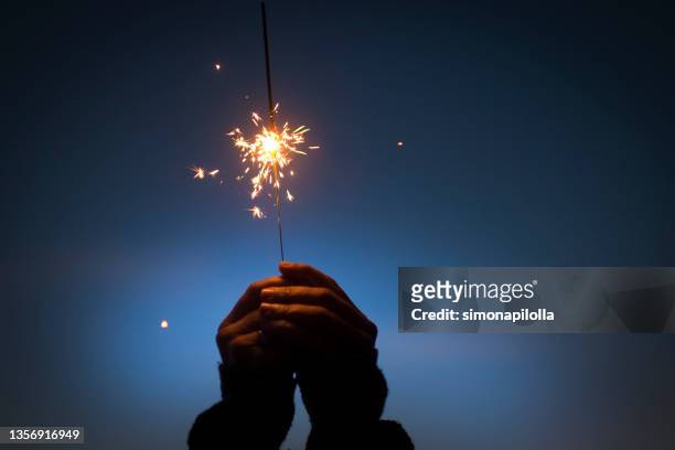 person holding sparkler at night - new year new you 2019 stock pictures, royalty-free photos & images