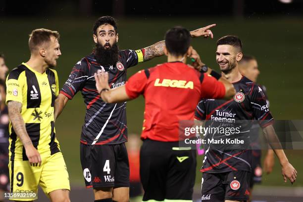 Rhys Williams of the Wanderers points to the big screen replay as the referee waits for the VAR leading to a Wanderers goal during the A-League Mens...