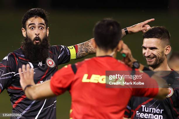 Rhys Williams of the Wanderers points to the big screen replay as the referee waits for the VAR leading to a Wanderers goal during the A-League Mens...