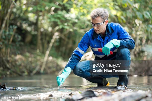 water quality testing solution and outdoors laboratory services. biologists are collecting samples of toxic water for improvement and water sustainable development. - biologist stock pictures, royalty-free photos & images