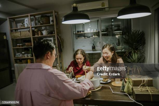 family activity, having dinner at home on weekend together-stock photo - family trip in laws stock pictures, royalty-free photos & images