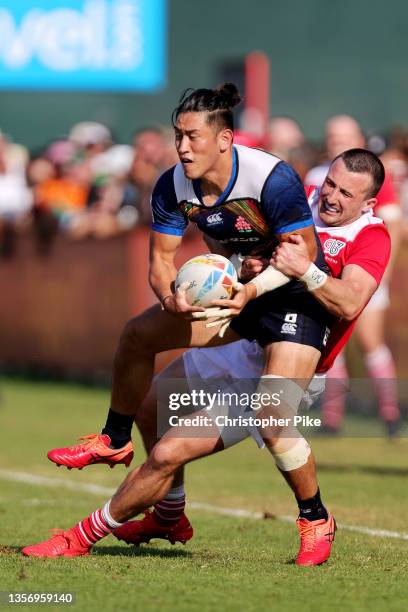 Moeki Fukushi of Japan is tackled by Alex Davis of Great Britain during the match between Japan and Great Britain on Day One of the HSBC World Rugby...