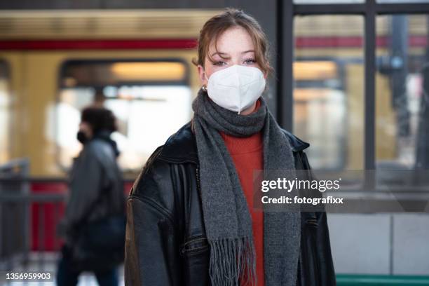 teenage girl wearing a mask, standing on a train station platform - one teenage girl only stock pictures, royalty-free photos & images