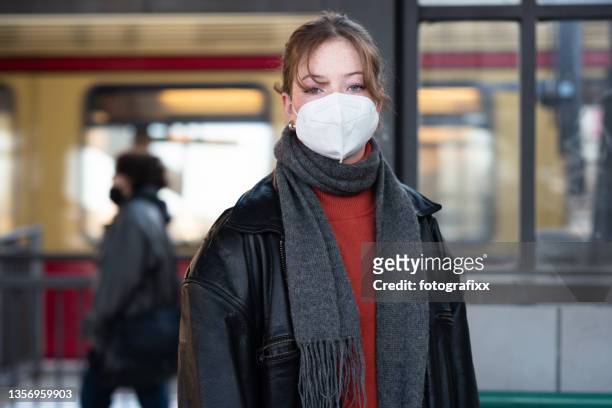 teenage girl wearing a mask, standing on a train station platform - one teenage girl only imagens e fotografias de stock
