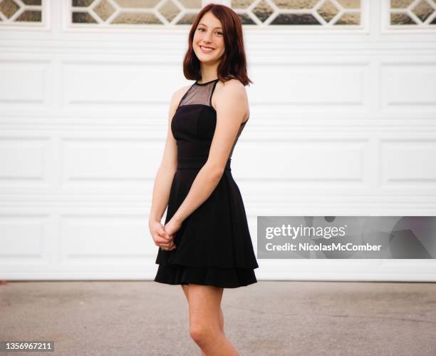 smiling portrait of a beautiful female teenager in her homecoming dress - cocktail dress stock pictures, royalty-free photos & images